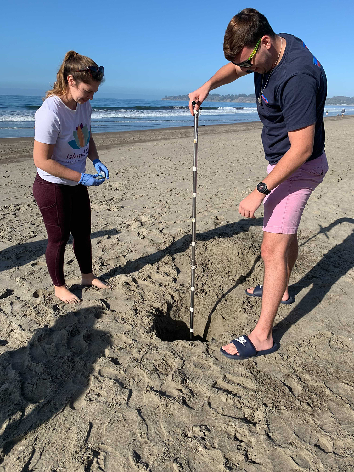 Pictured are researchers Jessica Bullington and Jacob Phaneuf collecting samples from beach groundwater.