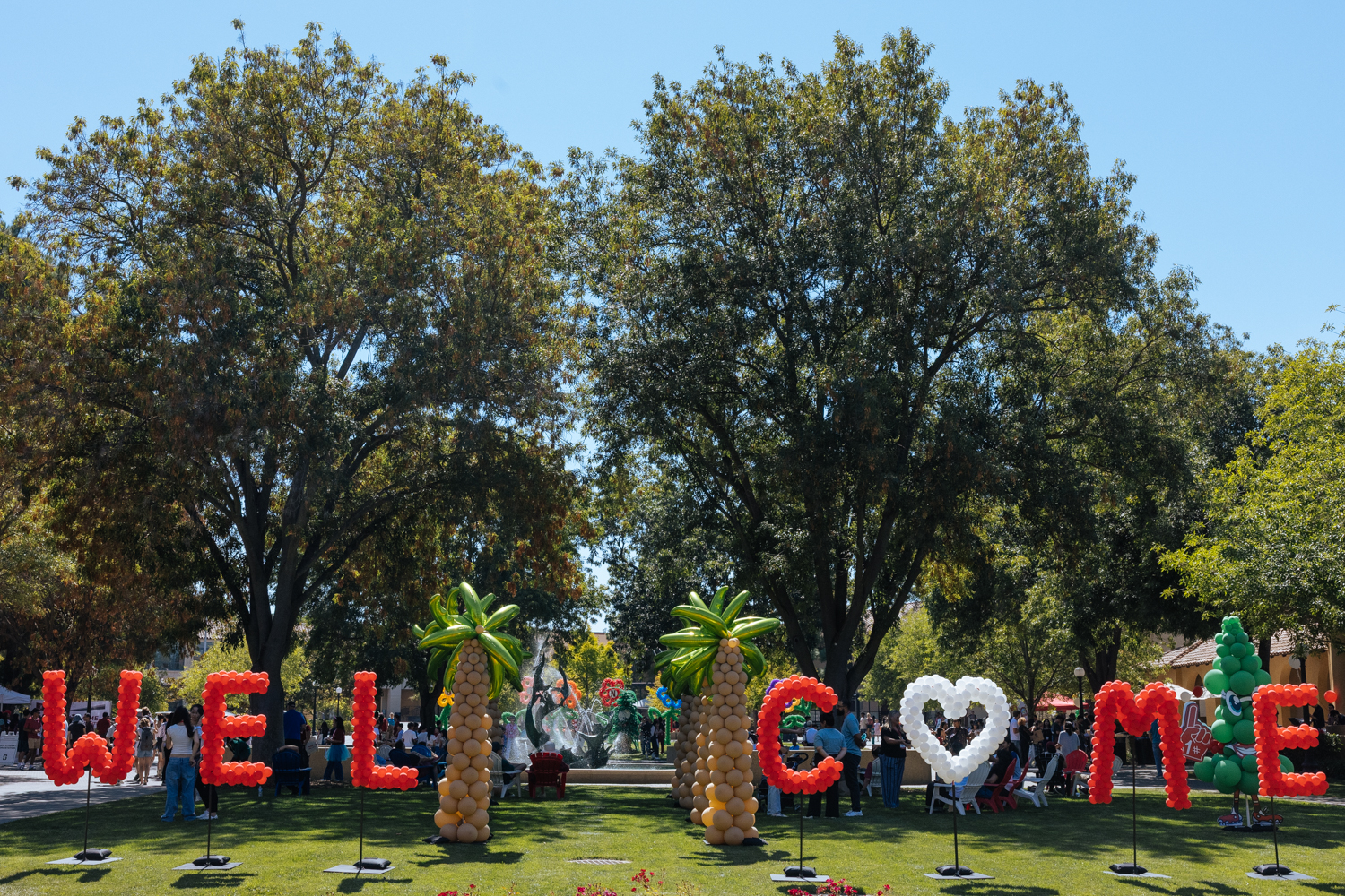 Balloons of palms and letters spelling out WELCOME at White Plaza.