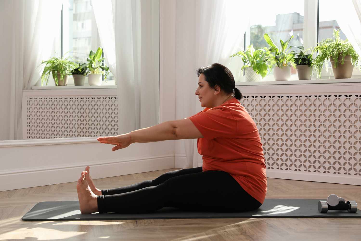 Image of a person doing stretches on a exercise mat.