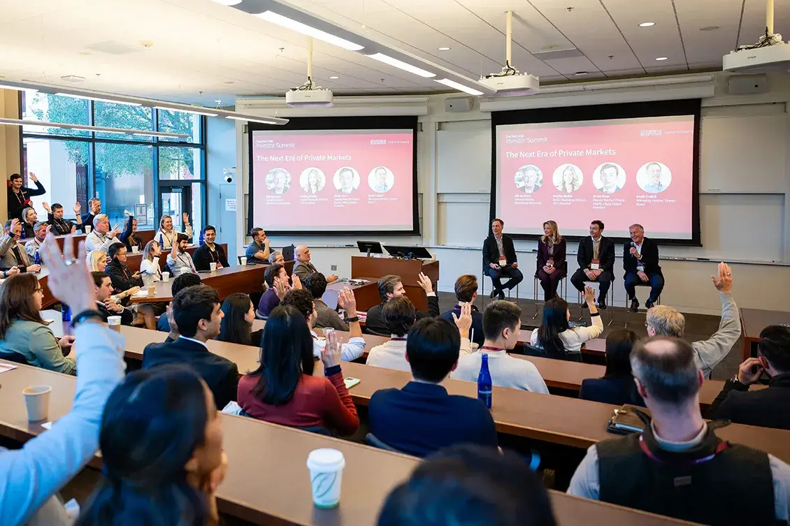 An audience engages with panelists at a session titled "The Next Era of Private Markets."