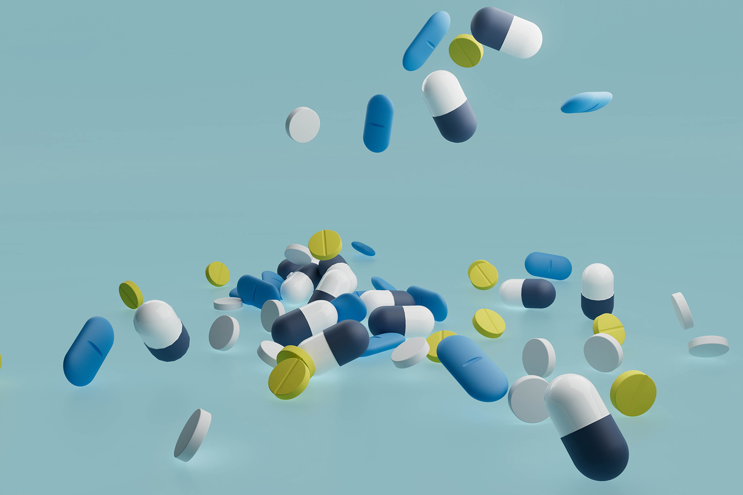Colorful capsules and tablets scattered against a light blue background.