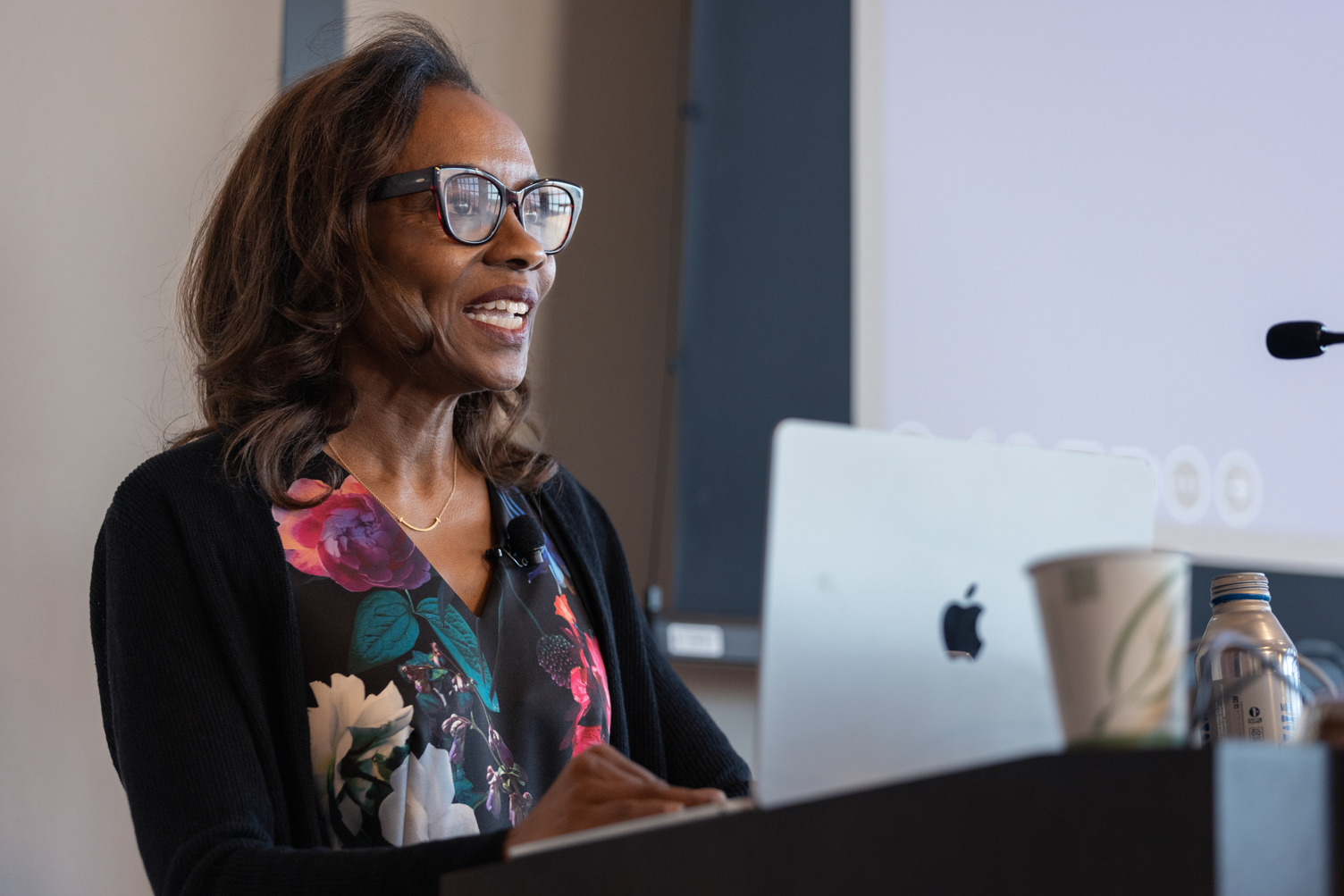 Jennifer Eberhardt stands at a podium with a laptop, engaged in a presentation on Sept. 12, 2024.