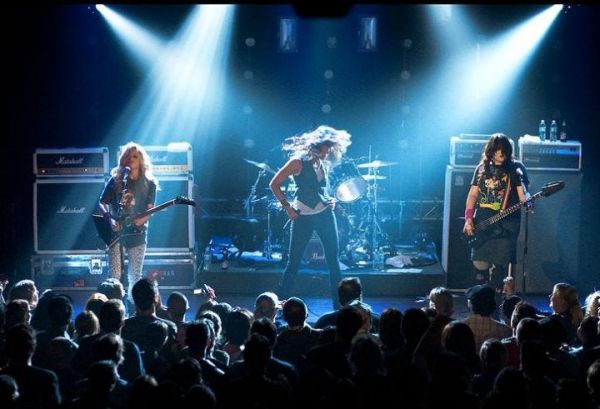 The Donnas on stage in front of a crowd.