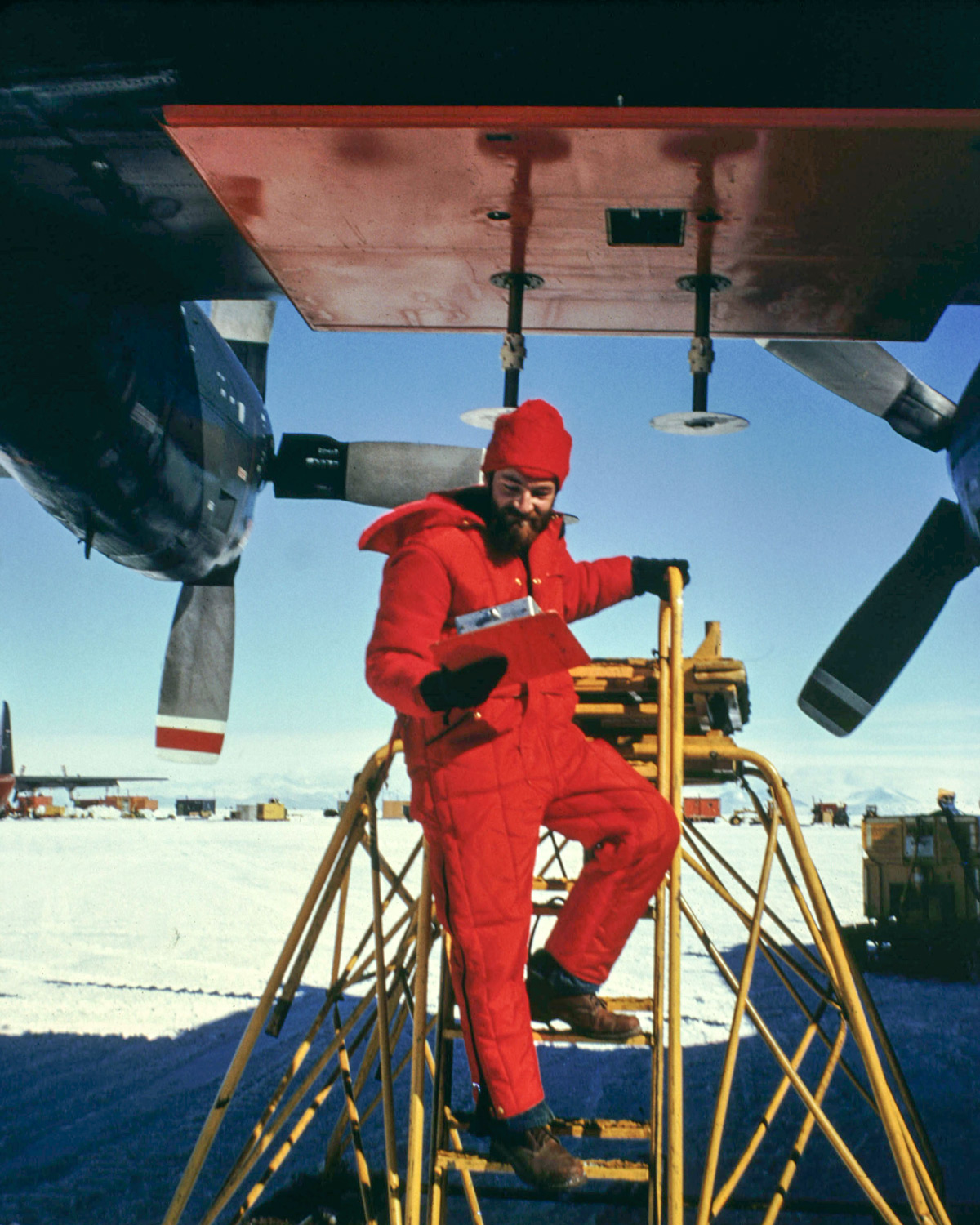 Nils Sko undertaking maintenance on a 300MHz radar antenna on a C-130 plane at McMurdo Sound in Antarctica.