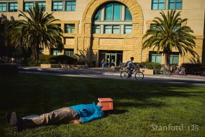 Student lying on grass.