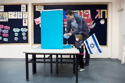 Israeli man with his daughter voting in Tel Aviv on March 17, 2015