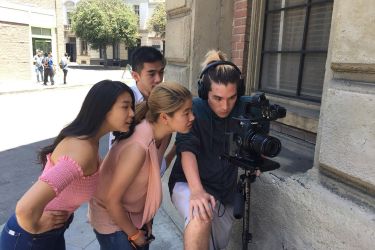 Da Eun Kim, Matt Shimura and actors on the set of Many Names at Warner Bros. Studios