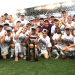 men's soccer team with NCAA trophy