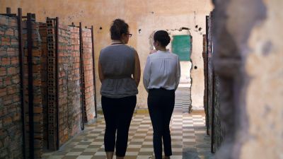 two women walking away down a hallway