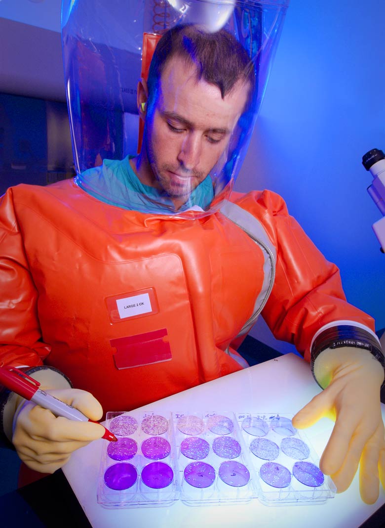 Scientist in protective suit in a biosafety level 4 lab