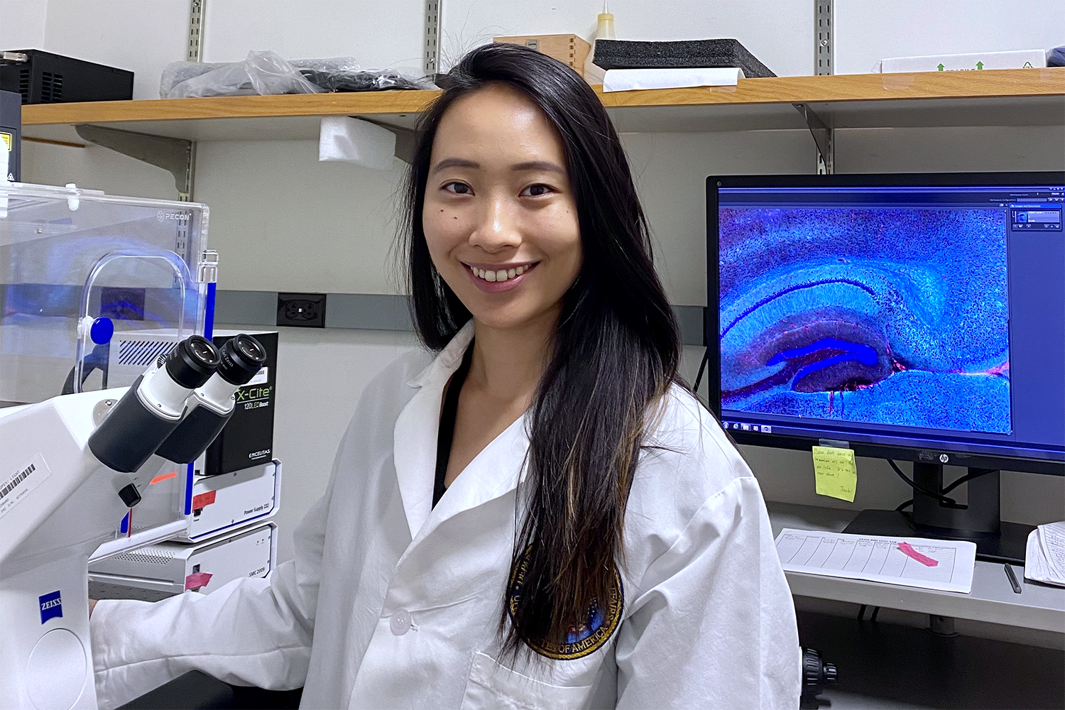 Profile image of Sophia Shi in a lab next to lab equipment.