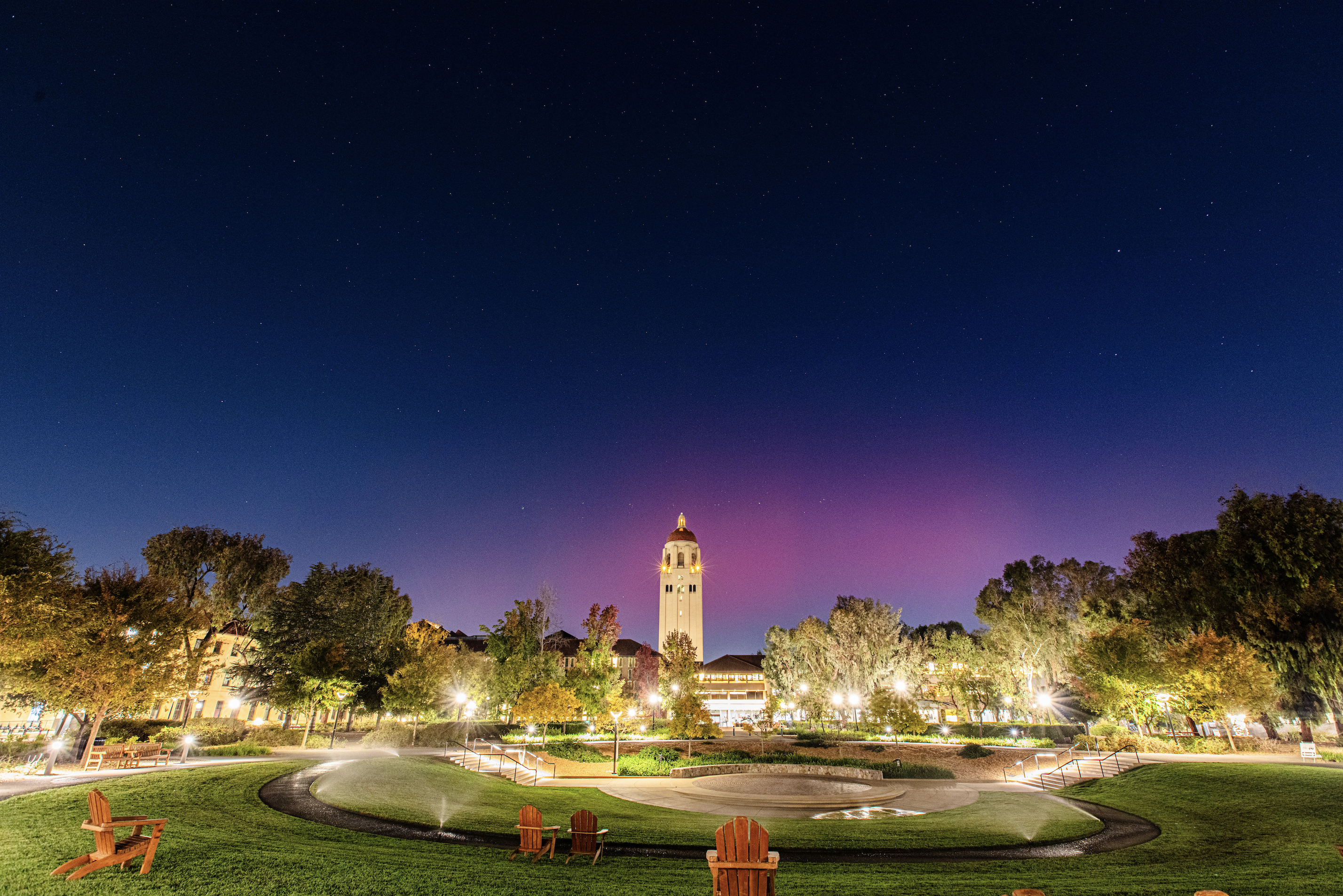 Image of the northern lights over Hoover Tower at night.