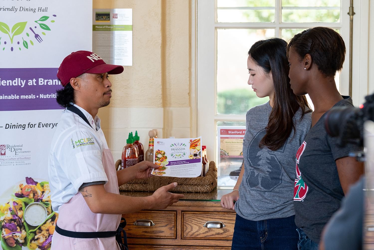 Image of Chef Jay-Ar Pugao talking with Abigail Bomin Kim and Eloise Vanessa Koudou.
