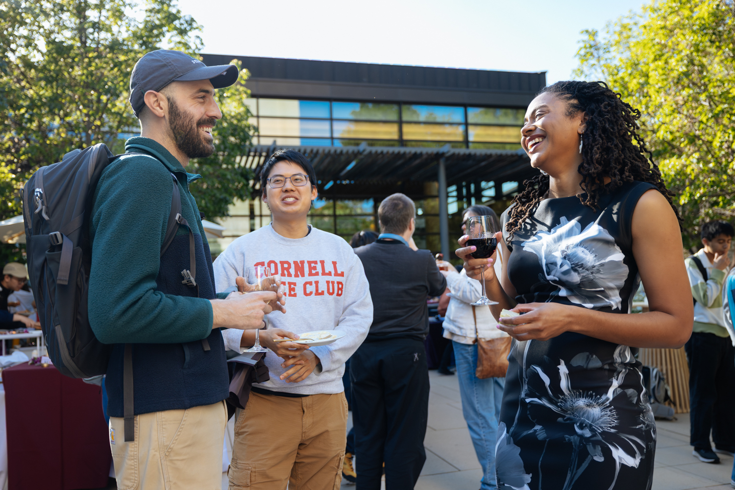 Orisa Coombs and friends with food and drinks smiling and chatting outdoors after the competition.
