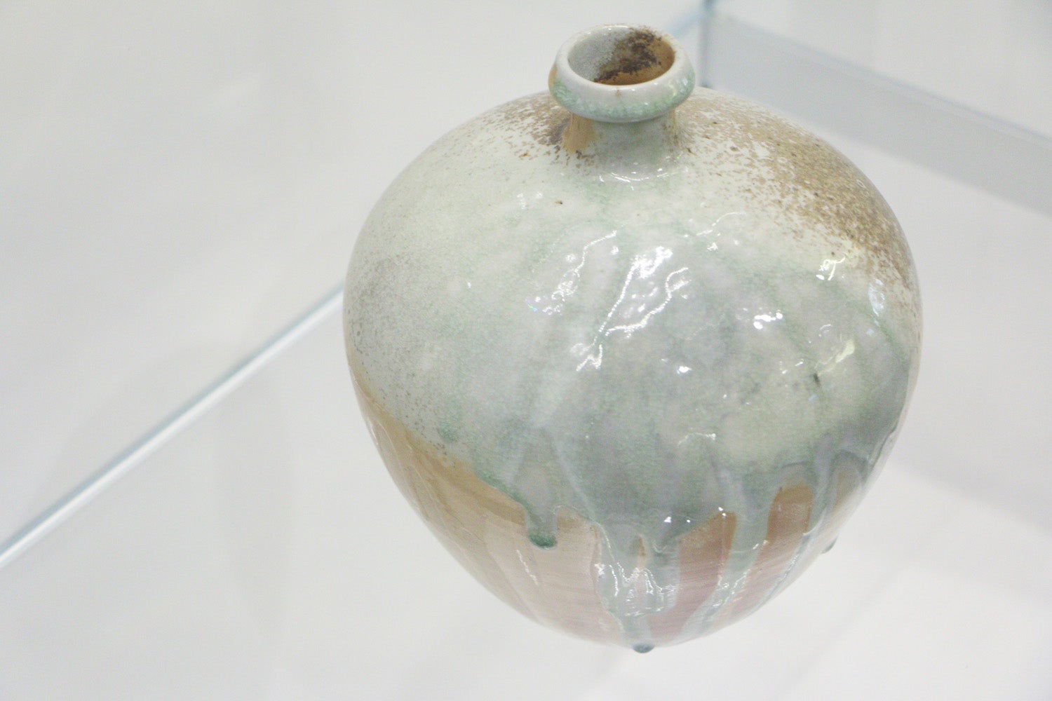 Iron contributes to the green tint of the drips on the side of this ceramic jar