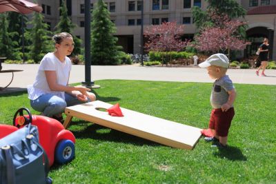 Student and children playing a lawn game.