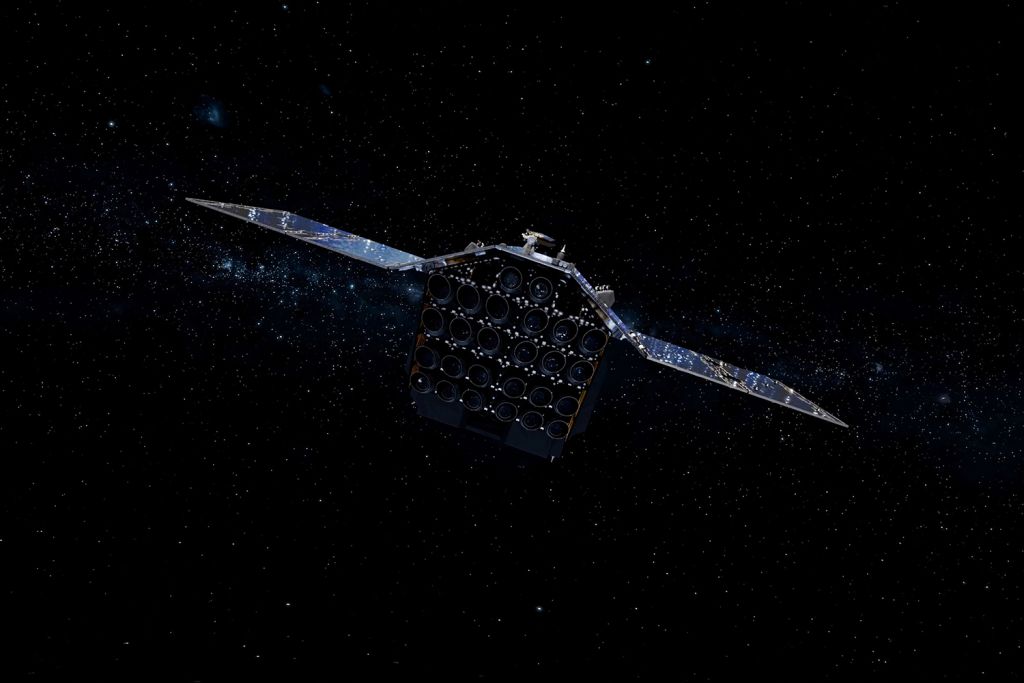 A satellite with large solar panels orbits in the dark expanse of space filled with stars.
