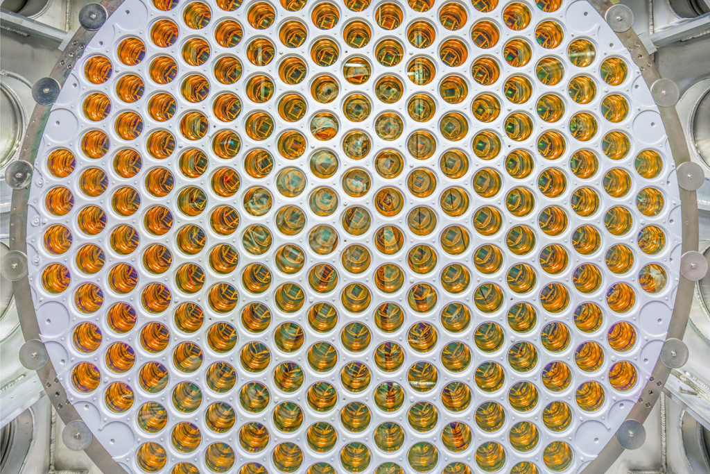 Close view of a circular array of hundreds of gold-toned light sensors packed into a white panel.