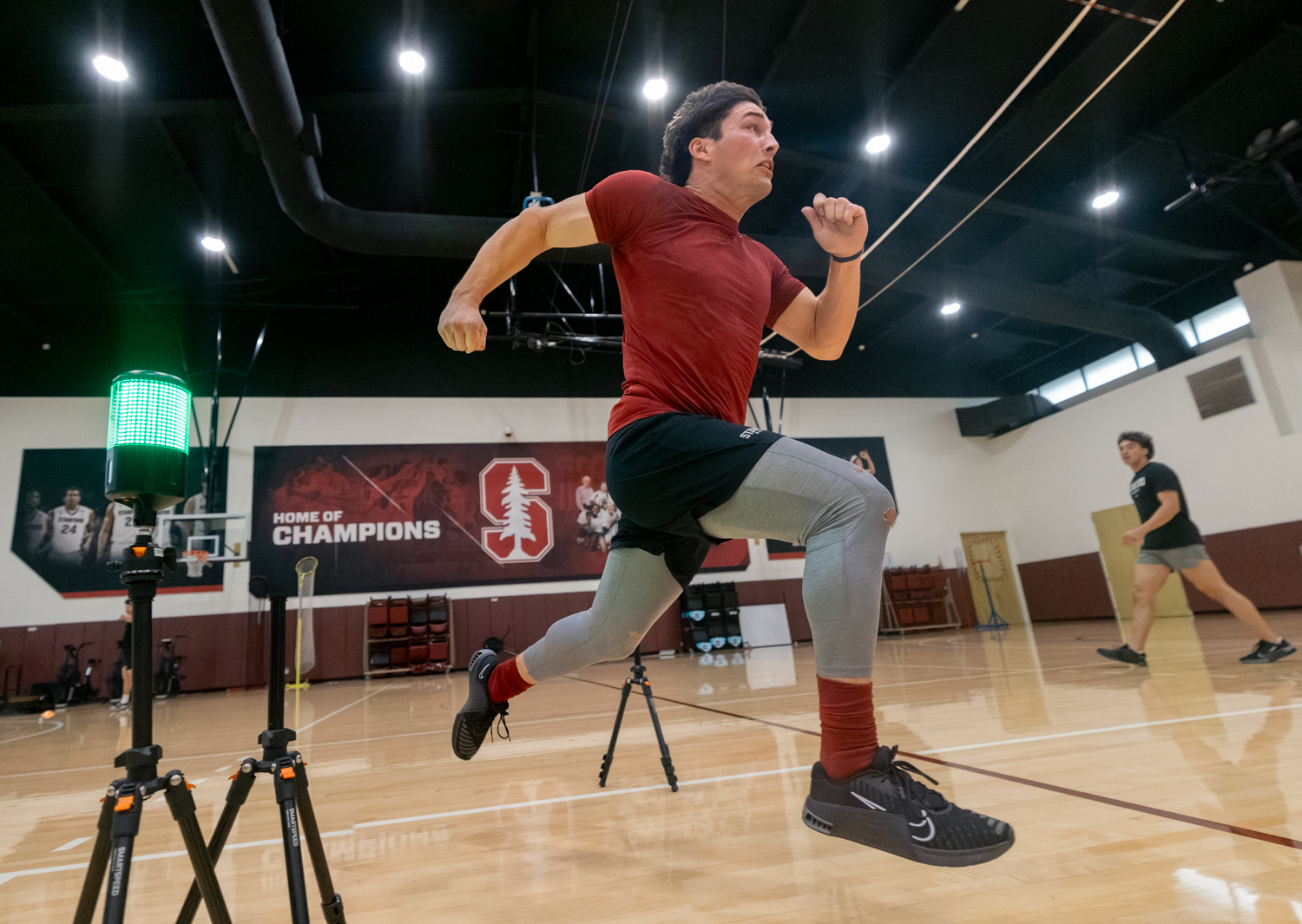 Photo of Stanford baseball outfielder Brady Reynolds doing sprints and clocking the time.