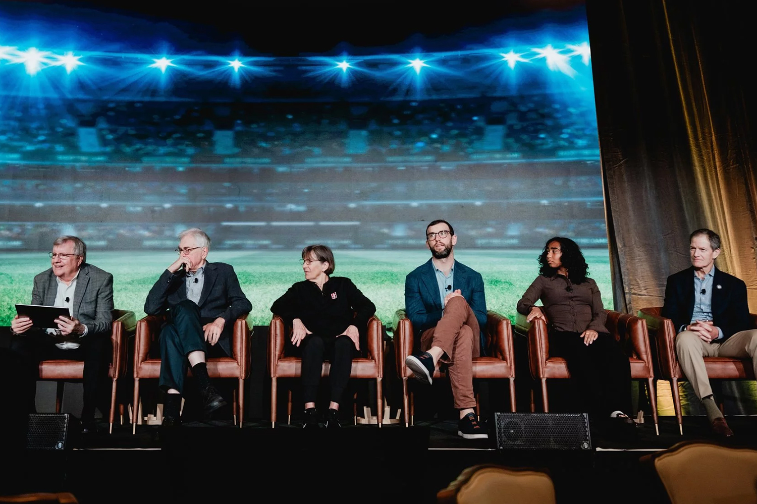 College sports panel at the 2025 SIEPR Economic Summit: From left to right, John Shoven, Roger Noll, Tara VanDerveer, Andrew Luck, Nya Harrison and Gene Sykes.