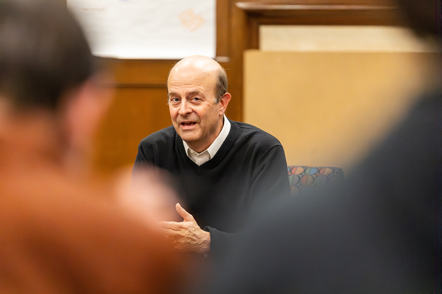 Jay Hamilton sitting and talking to students during a Civic Salon.