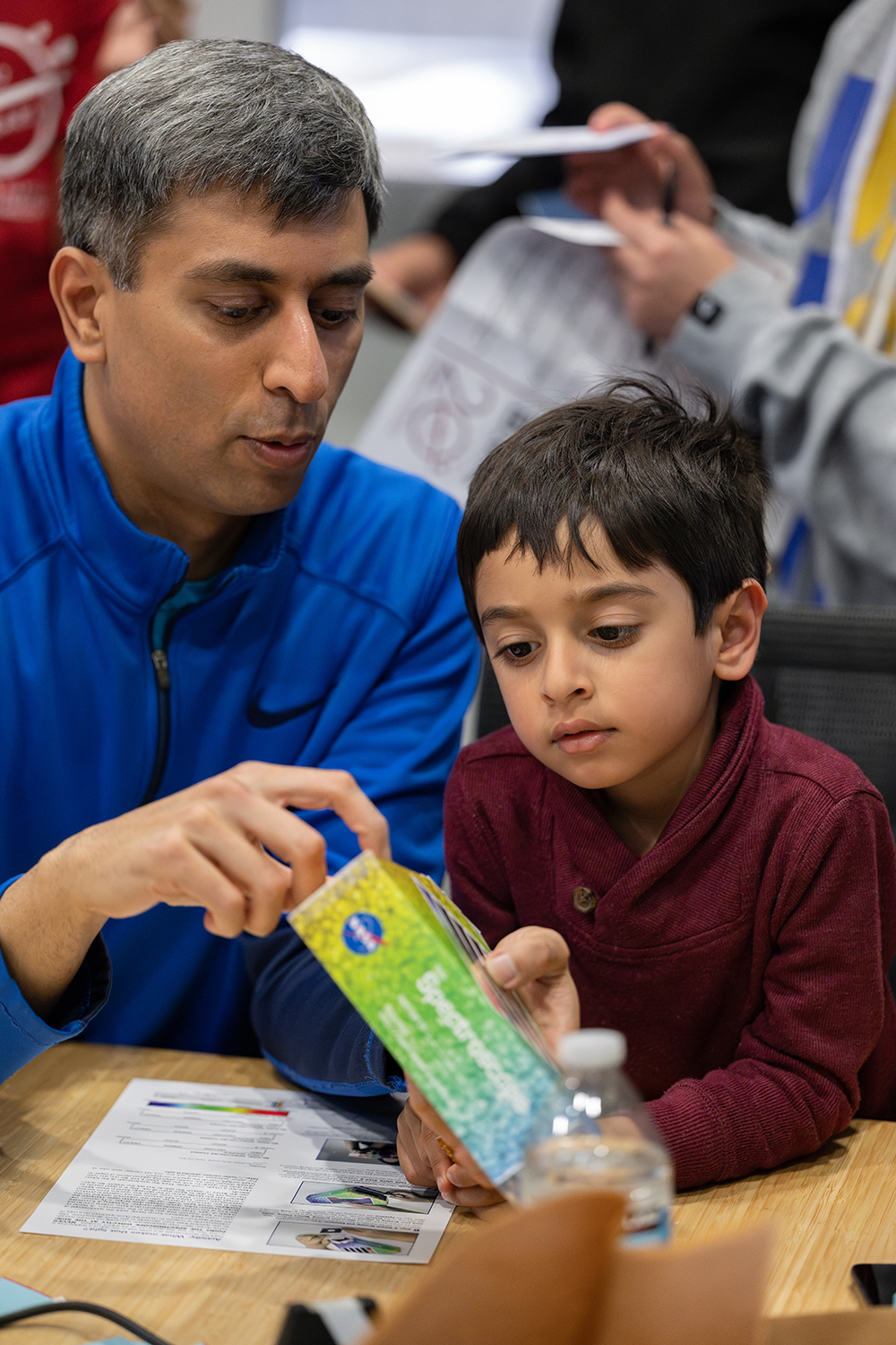 An image of a father and son bonding at one of the hands-on stations.
