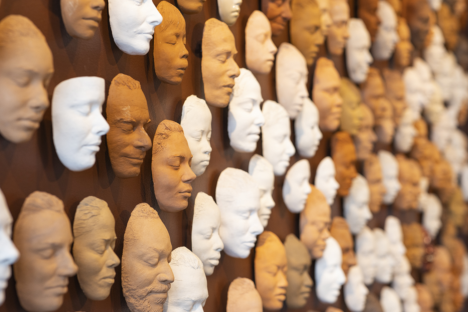 Detail of wall of masks that originally hung on the exterior of Ruth Asawa’s family home in Noe Valley, mounted as part of the long-term installation, The Faces of Ruth Asawa, at the Cantor Arts Center. 