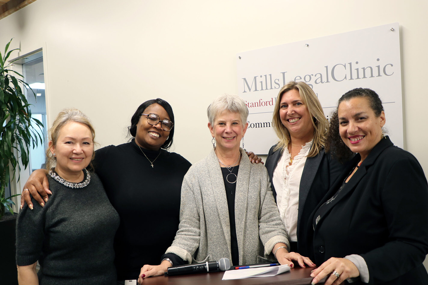 Image of Community Law Clinic leaders and staff posing for a photo with Juliet Brodie.