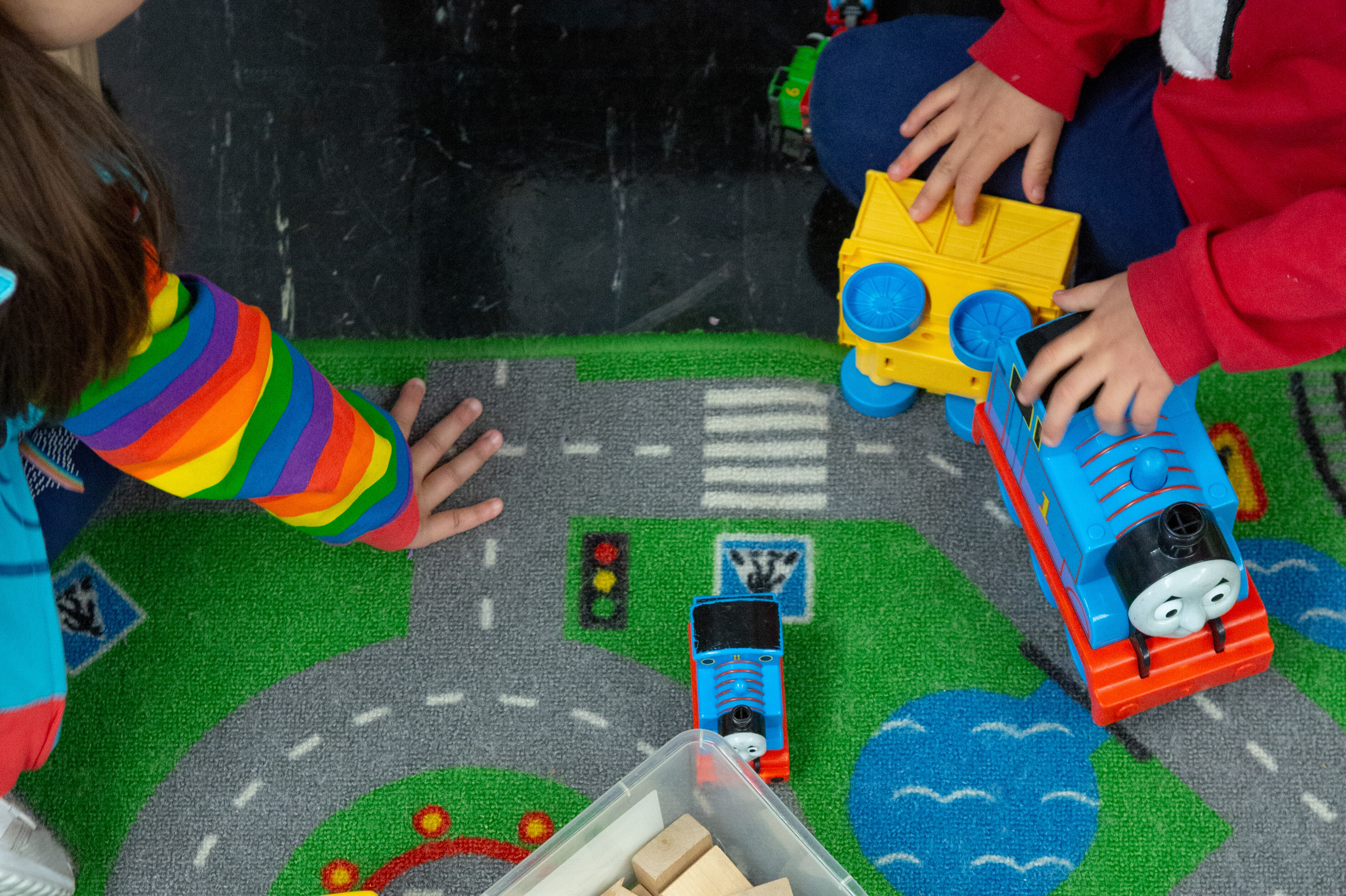 Kids playing with trains at a daycare facility or preschool