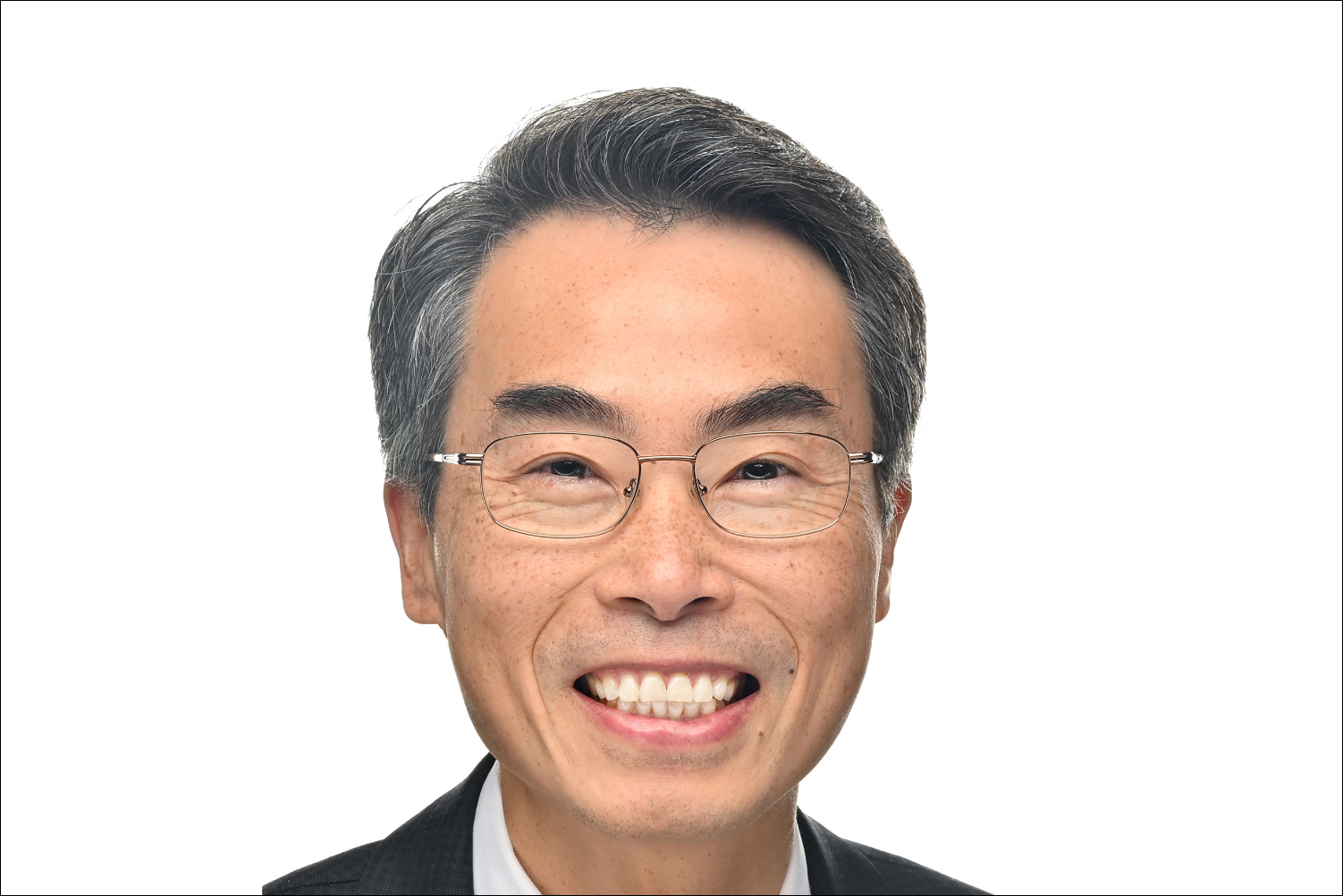 Joseph Wu smiling and wearing glasses and a dark jacket against a white background.