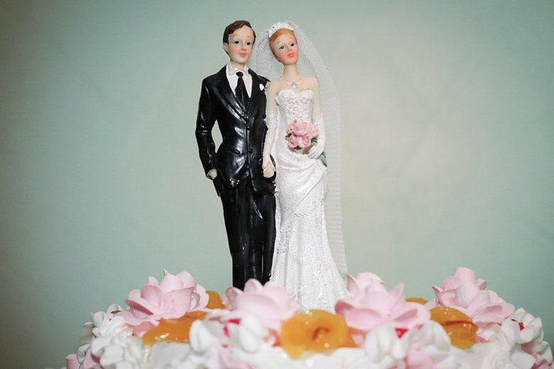 bride and groom figures atop wedding cake