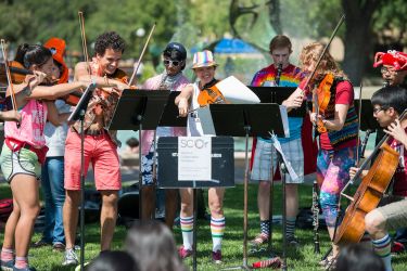 a student orchestra perform in White Plaza