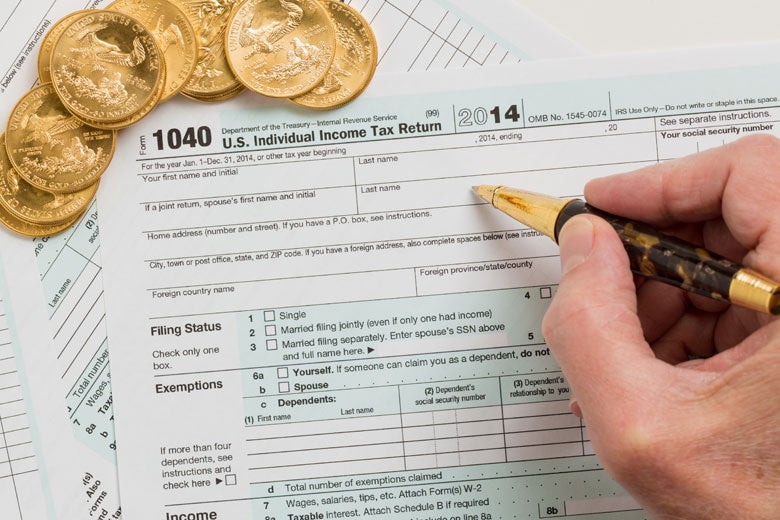 hand poised to fill out tax form 
