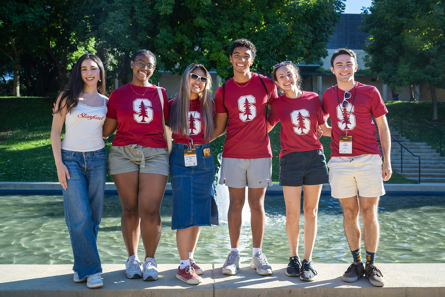 A group of students show off their Stanford T-shirts