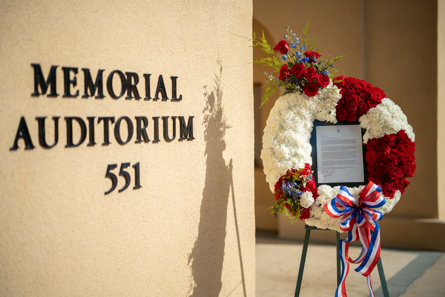 Memorial Auditorium building name with display of flowers