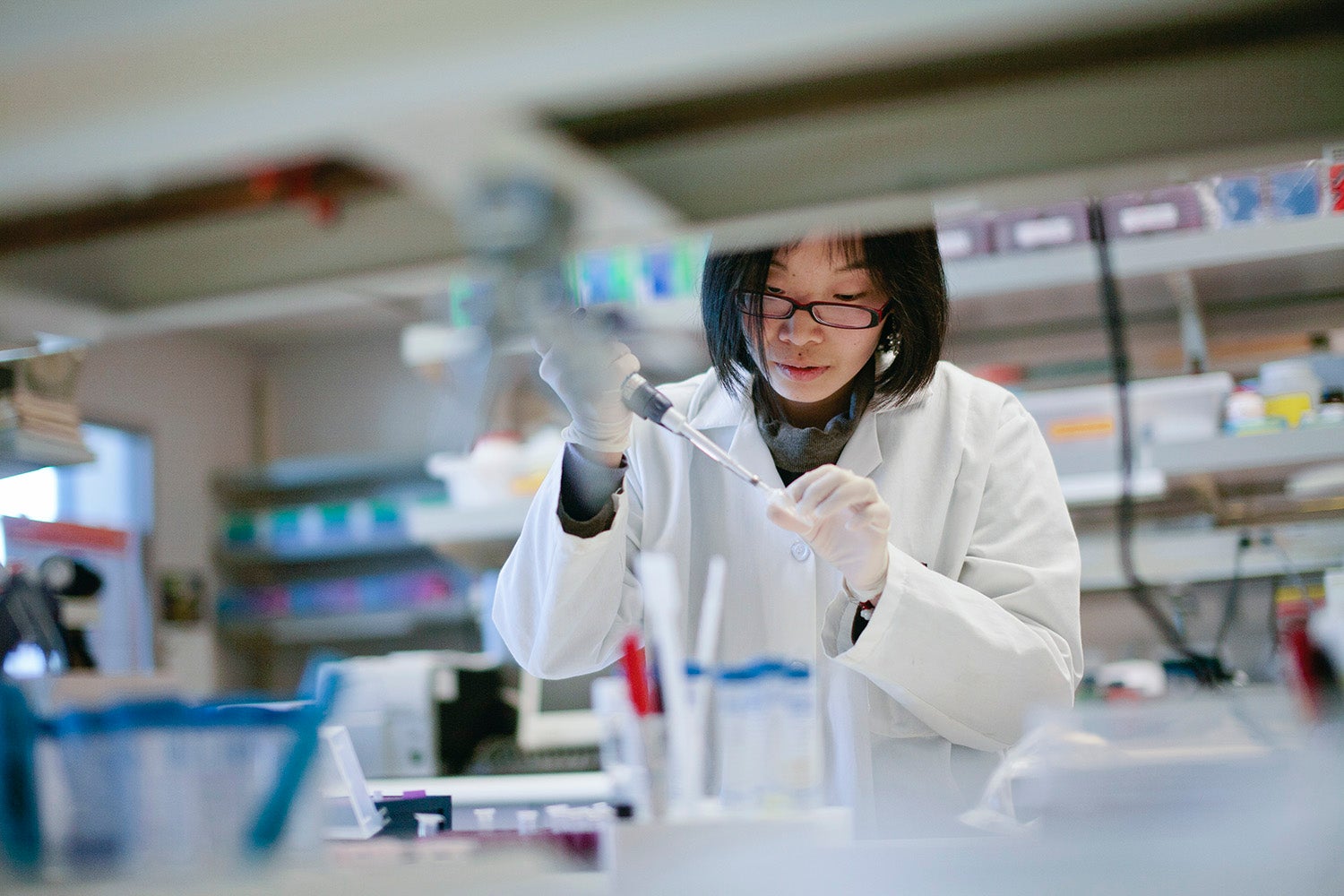 A scientist carefully conducts her experiment in a research laboratory.