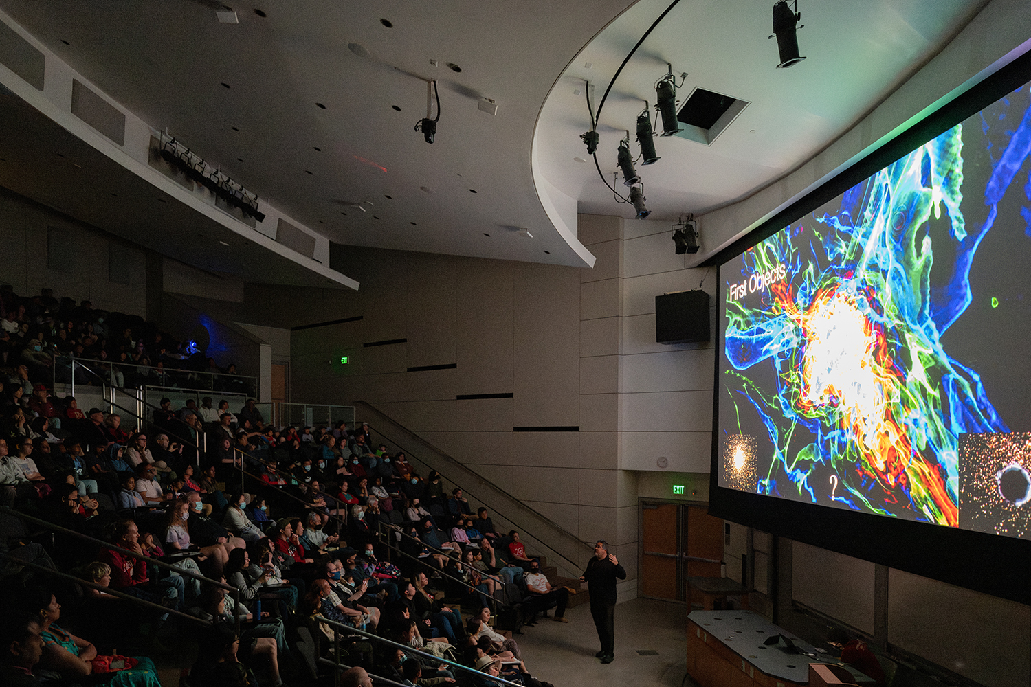 An image of Tom Abel giving a public lecture on the formation of first stars.