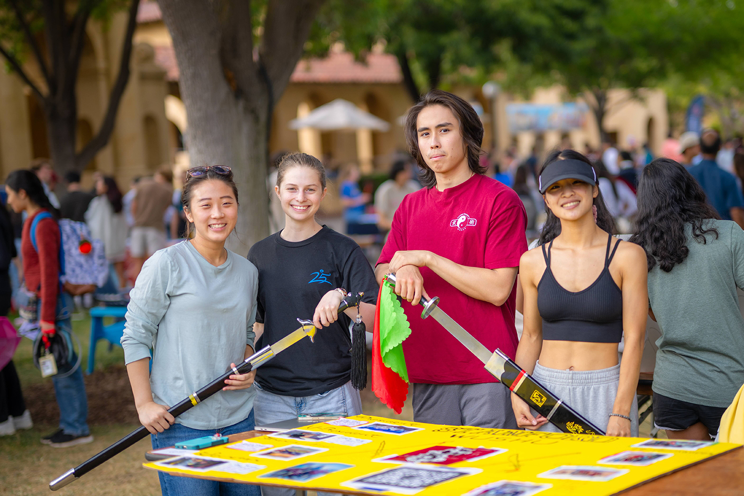 Image of Stanford Wushu Club members brandishing traditional Wushu weapons.