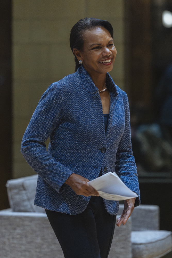 Condoleezza Rice in a blue tweed jacket holding notes for speech at 2025 Veterans Day celebration at the Hoover Institution