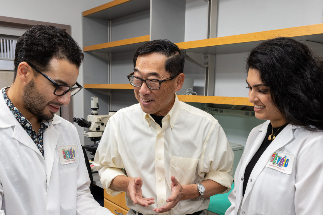 Stephan Ramos, Seung Kim and Preksha Bhagchandani in the lab discussing their research.