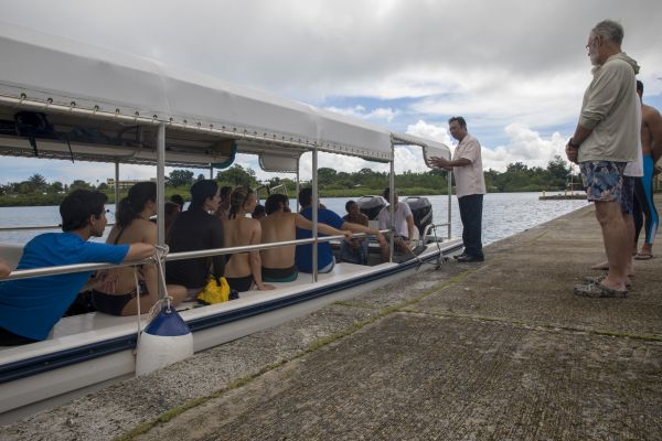The president of Palau standing by a boat of students