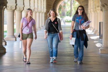 three women walking in arcade