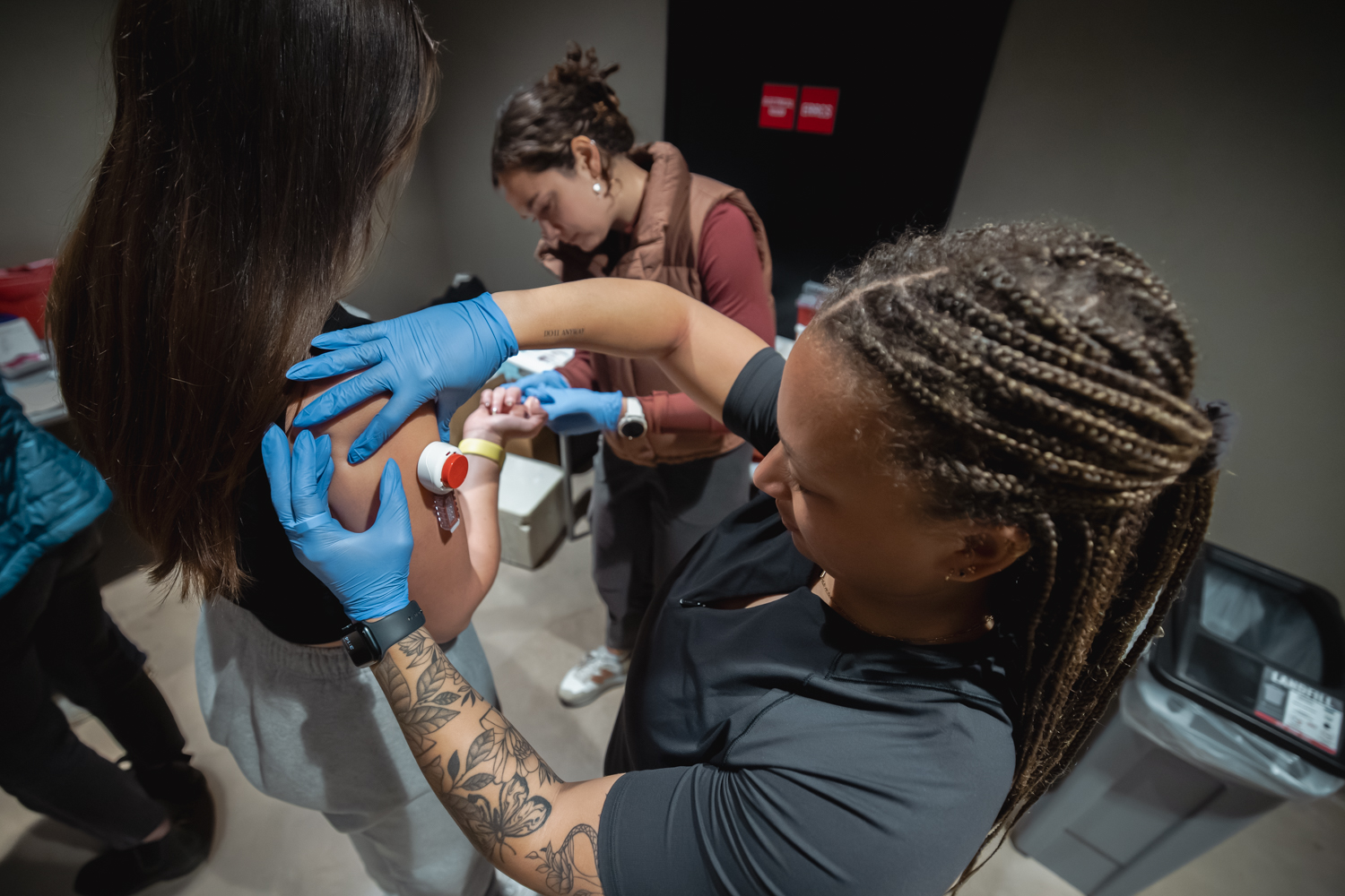 Postdoctoral scholar Morgan Smith draws blood from a member of the Stanford women’s rowing team.