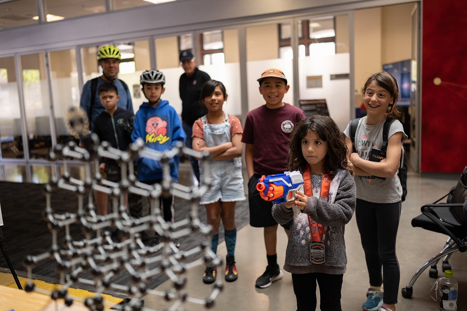 An image of a young participant shooting rubber bullets from a toy NERF gun.