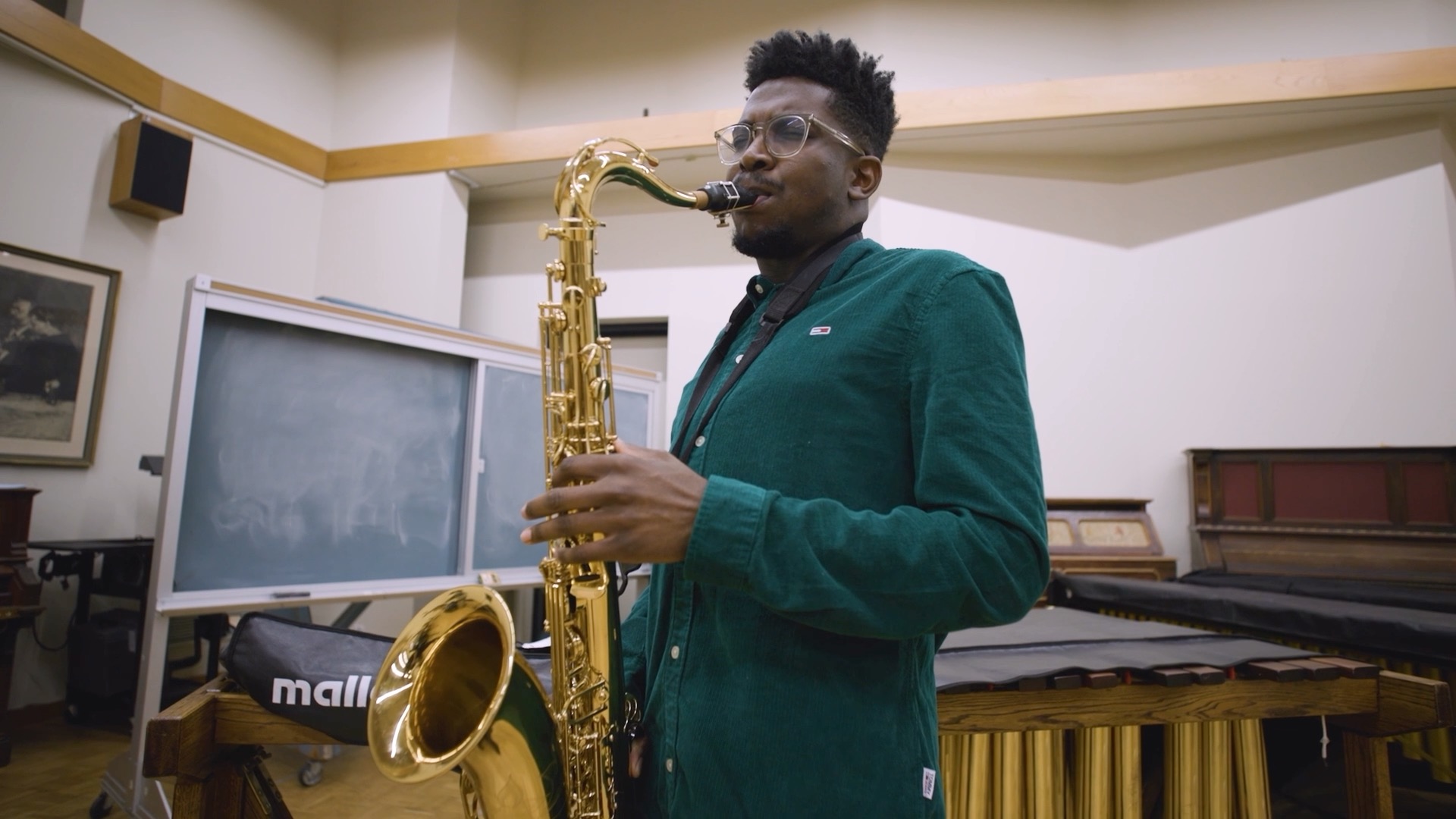Image of a person playing a tenor saxophone. 