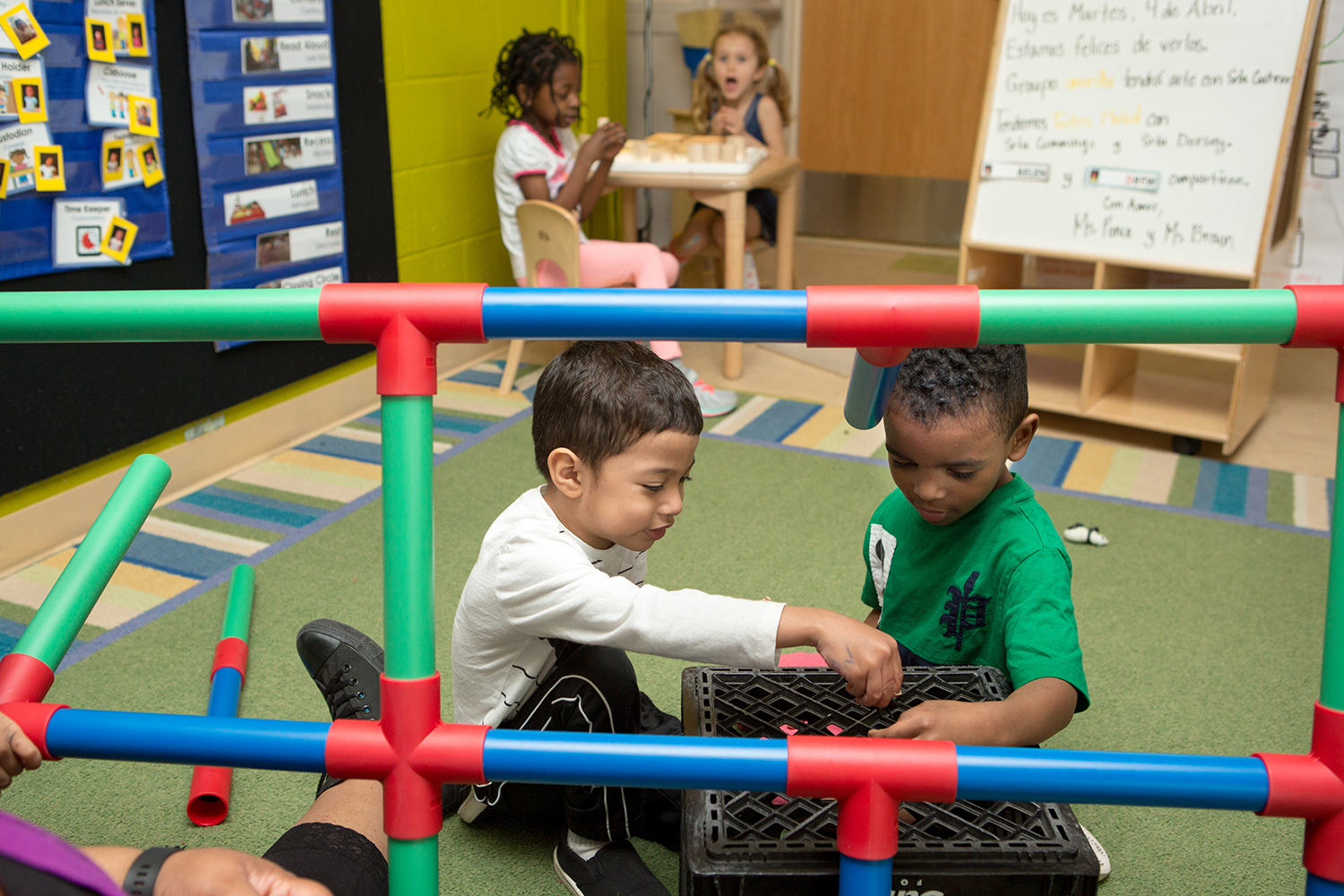 Image of children playing and doing activities in a classroom.