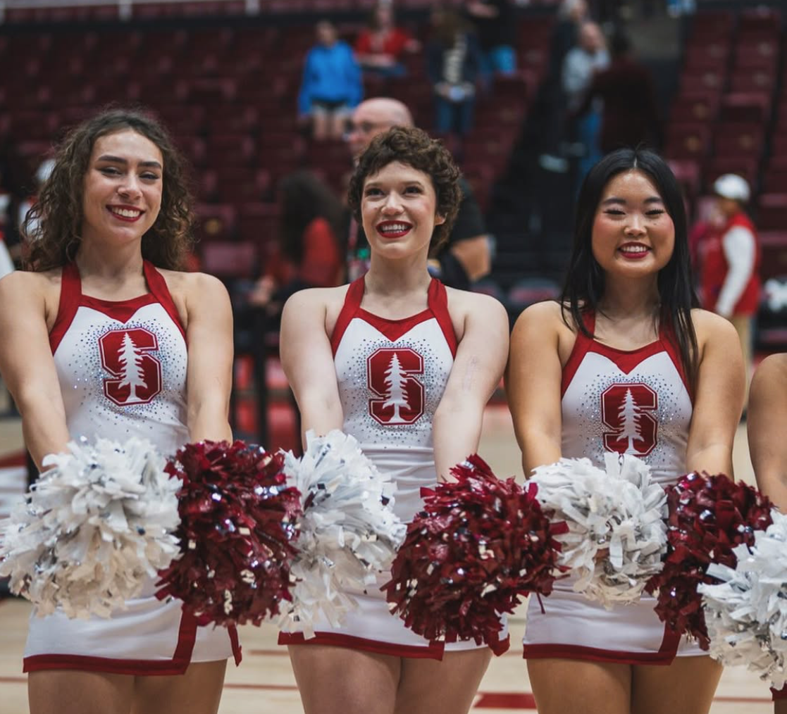 Josie Fabian with pom-poms on the Stanford cheerleading team