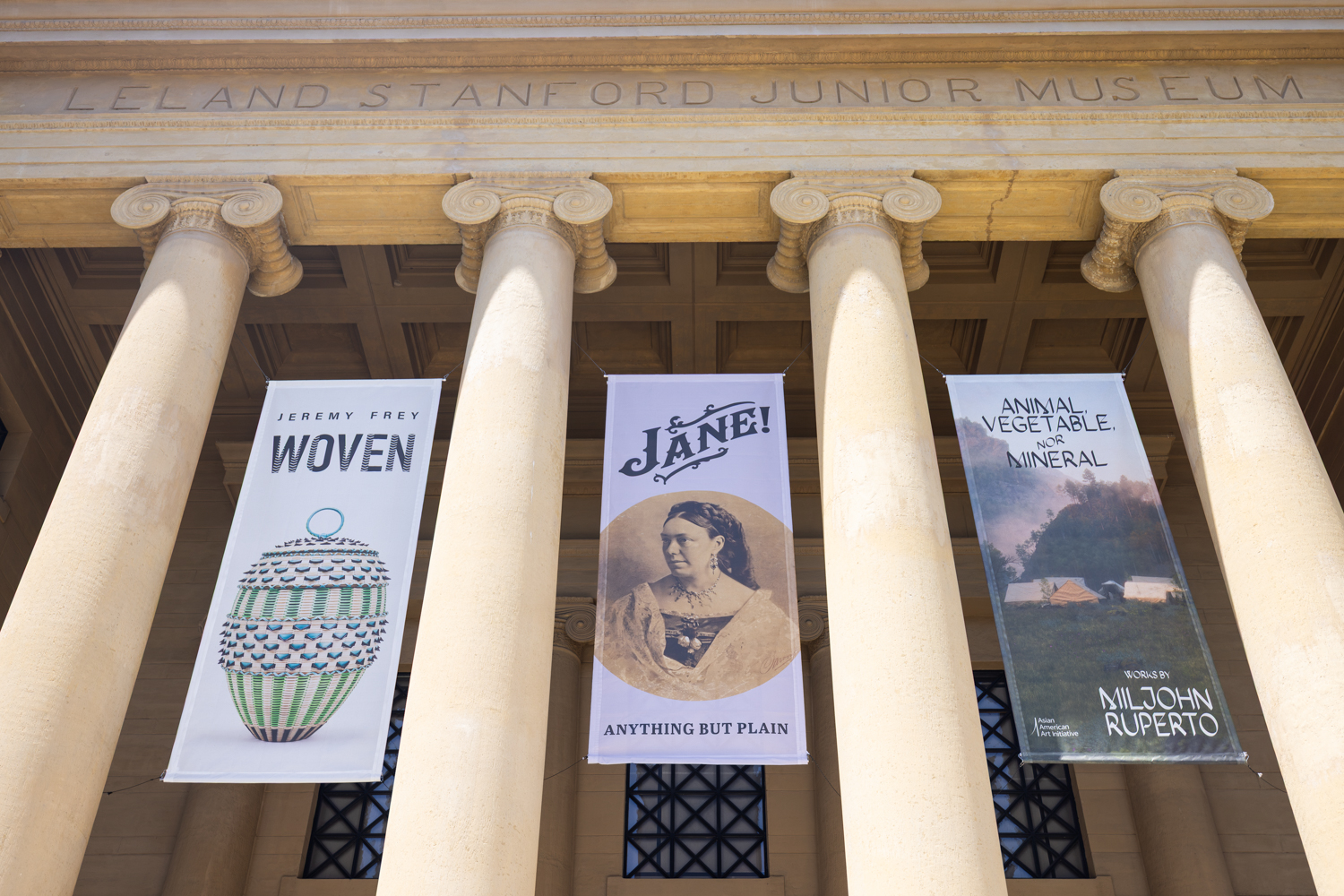 Banners featuring upcoming exhibitions hang from columns at the Cantor Arts Center, promoting 