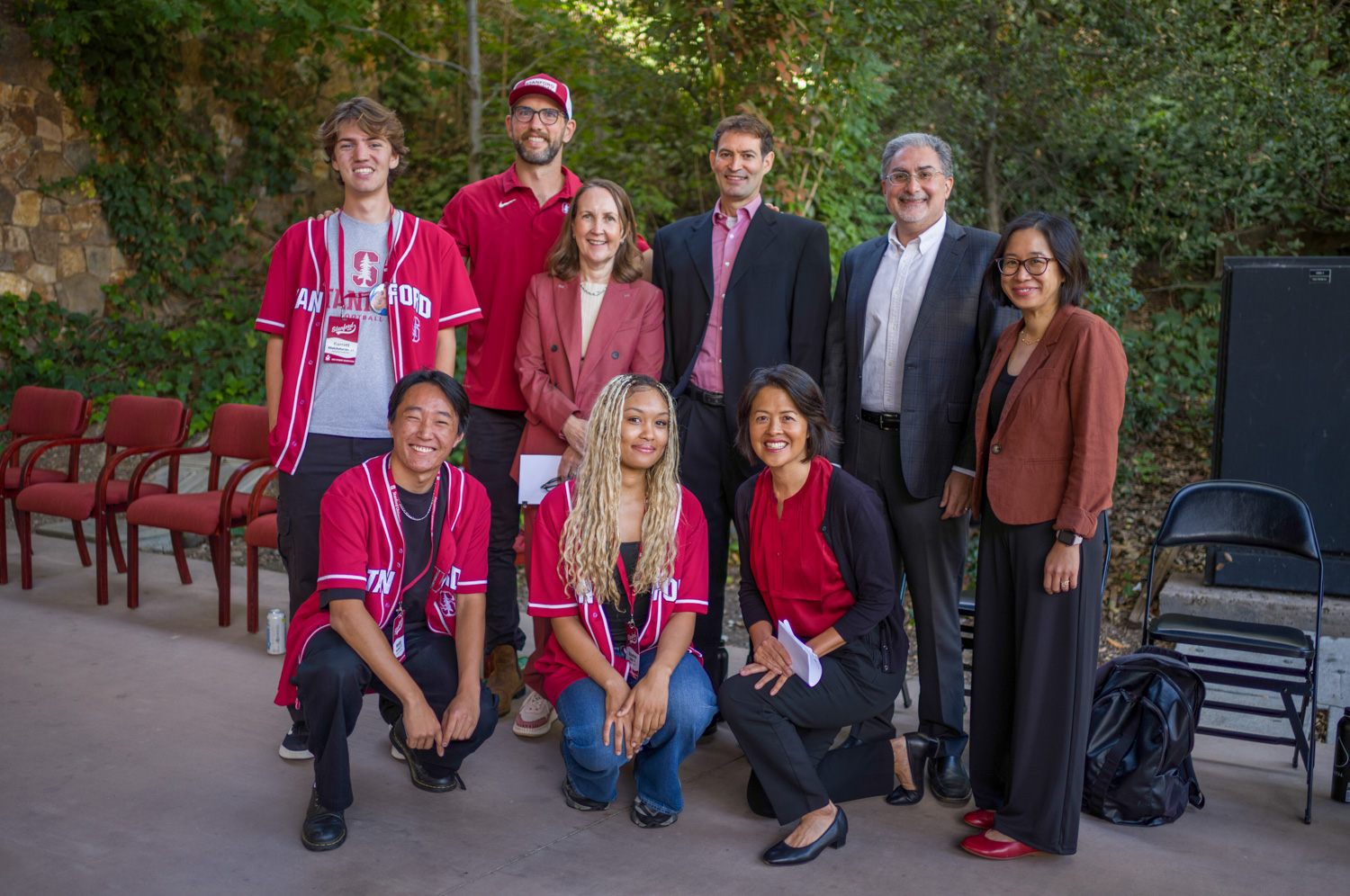Panel speakers and students pose together for a group photo after a campus discussion event.