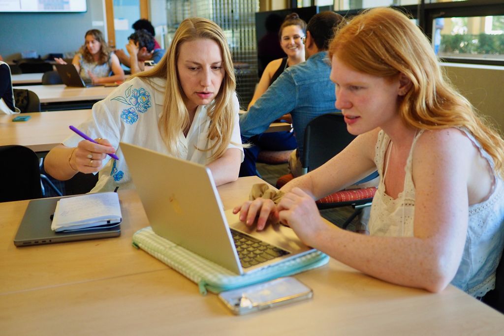 An instructor and student work on a syllabus review activity at the Center for Teaching and Learning Course Design Institute.